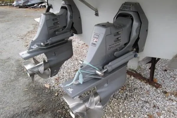 Slide: The Image of 2004 Crownline 288 BR boat propellers and outdrives on gravel surface. - 5