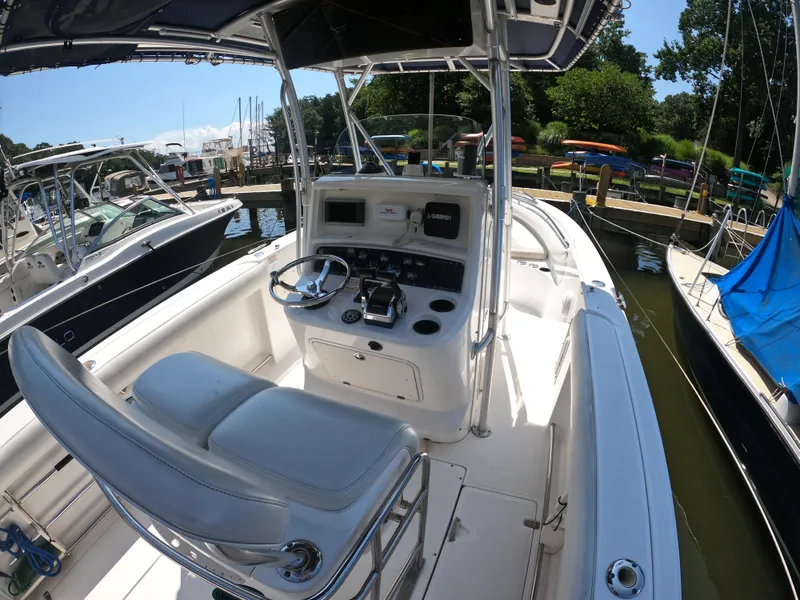 Slide: The Image of 2004 Boston Whaler 270 Outrage boat interior with helm, docked at marina. - 11