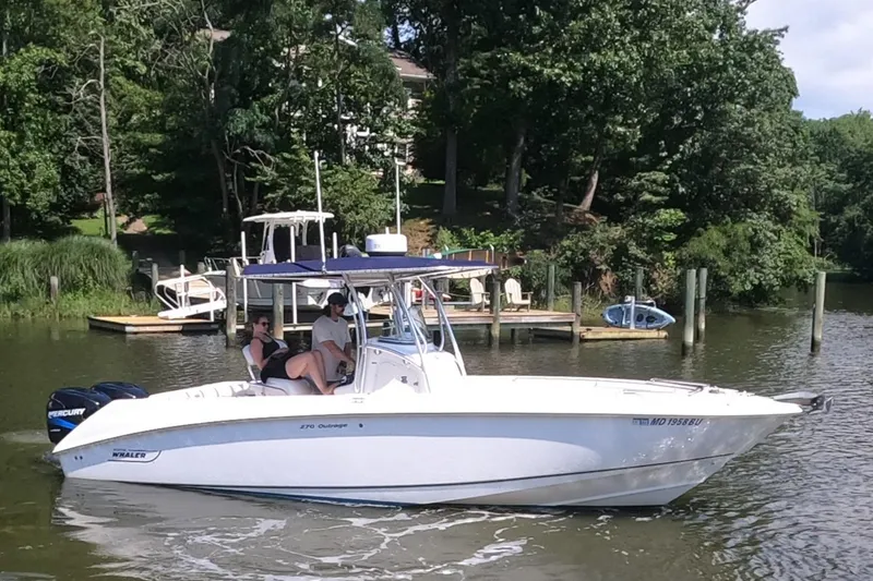 Slide: The Image of 2004 Boston Whaler 270 Outrage boat cruising on a scenic lake. - 2
