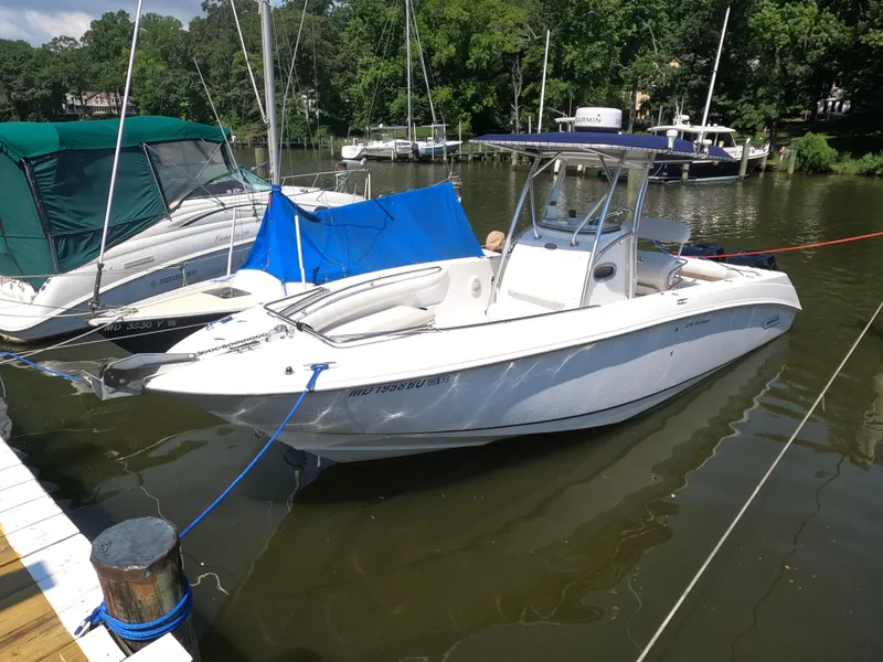 Slide: The Image of 2004 Boston Whaler 270 Outrage boat docked on a calm river. - 7