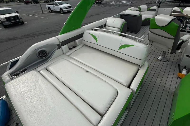 Slide: The Image of 2020 Berkshire 23SB STS Entertainment boat with green and white seating in a parking lot. - 10