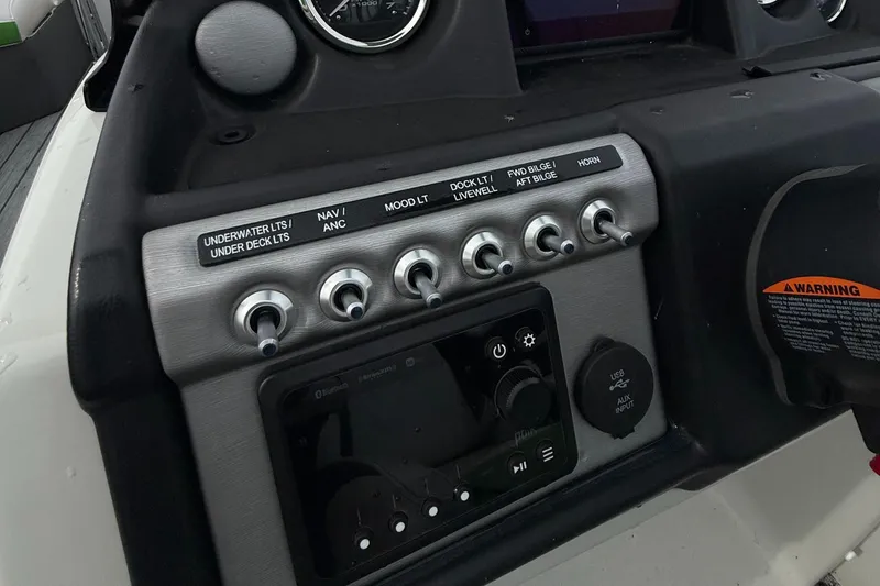 Slide: The Image of Control panel of a 2020 Berkshire 23SB STS Entertainment boat with switches and gauges. - 11