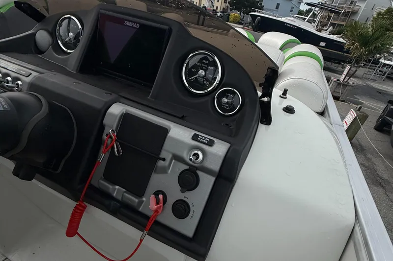 Slide: The Image of Dashboard of a 2020 Berkshire 23SB STS Entertainment boat with gauges and controls. - 12