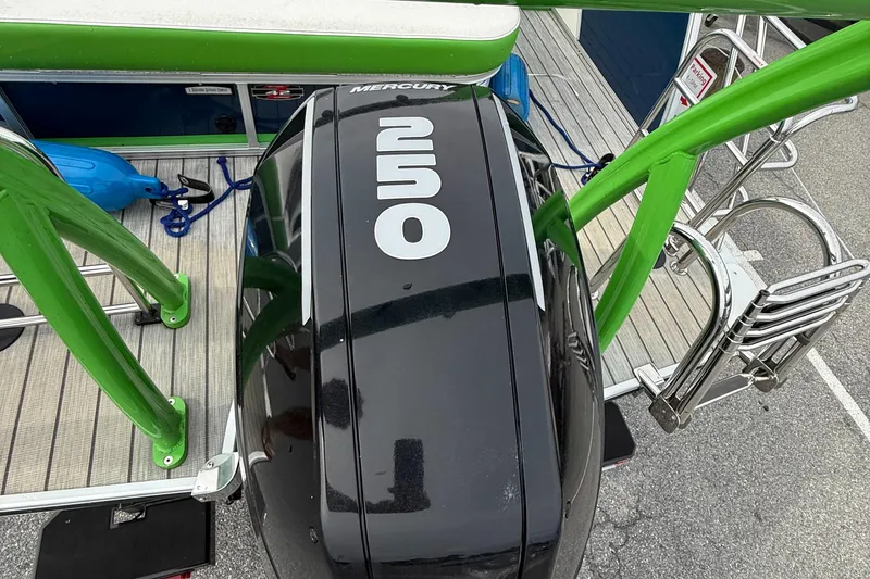 Slide: The Image of 2020 Berkshire 23SB STS Entertainment boat with Mercury outboard motor and green accents. - 14