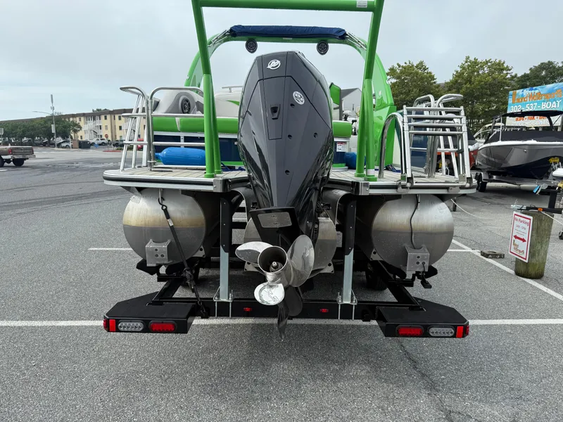 Slide: The Image of 2020 Berkshire 23SB STS Entertainment pontoon boat with outboard motor in a parking lot. - 3