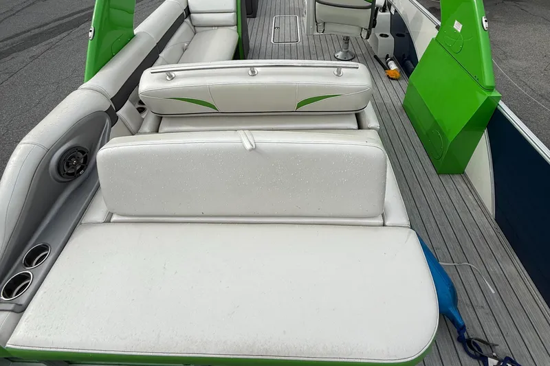 Slide: The Image of 2020 Berkshire 23SB STS Entertainment boat with white and green seating on a wooden deck. - 8