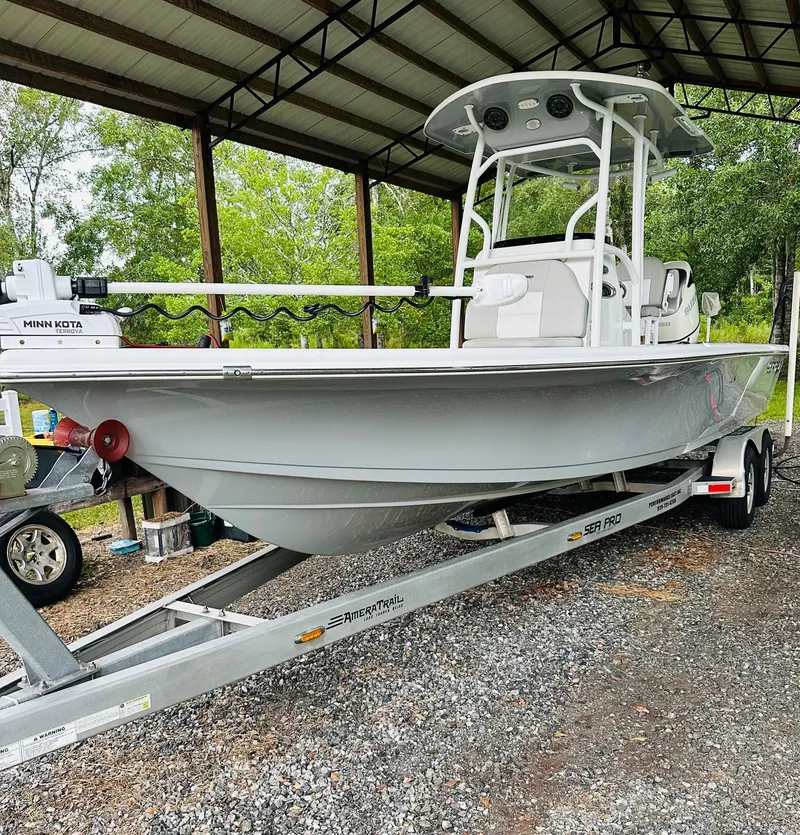 Slide: The Image of 2019 Sea Pro 248 Bay boat on trailer under shelter, side view. - 1