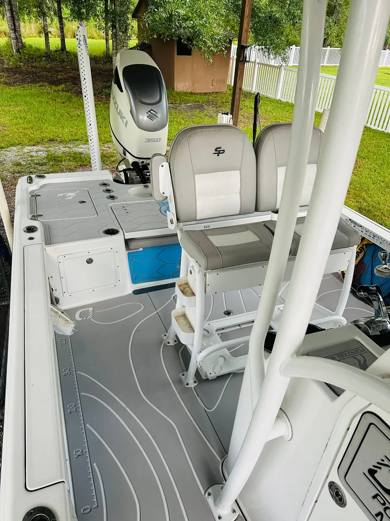 Slide: The Image of 2019 Sea Pro 248 Bay boat interior with dual seats and Suzuki engine. - 11