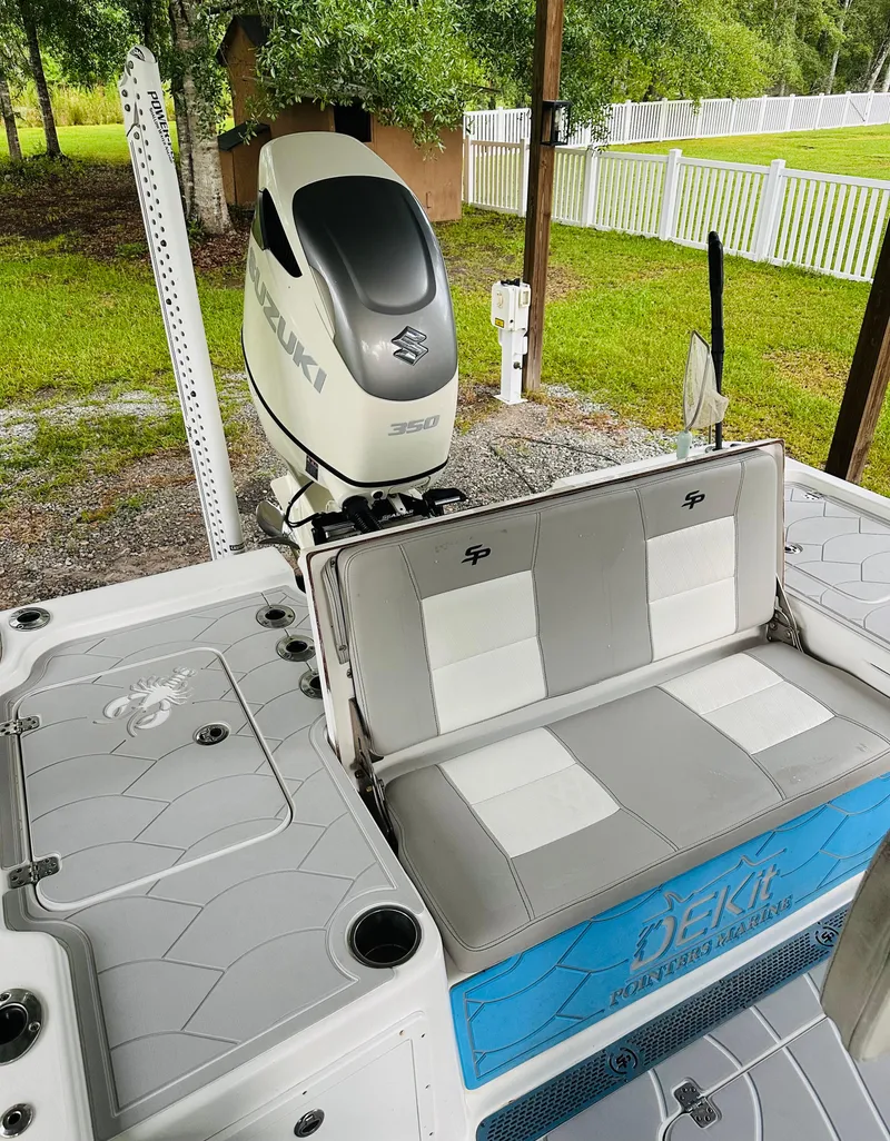 Slide: The Image of 2019 Sea Pro 248 Bay boat with Suzuki 350 engine, featuring gray and white seating. - 14