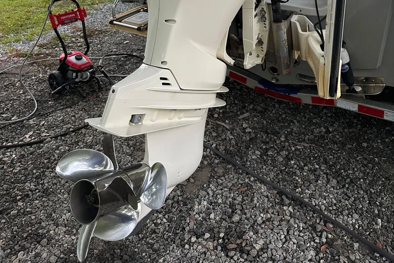 Slide: The Image of 2019 Sea Pro 248 Bay boat motor and propeller on gravel surface. - 16
