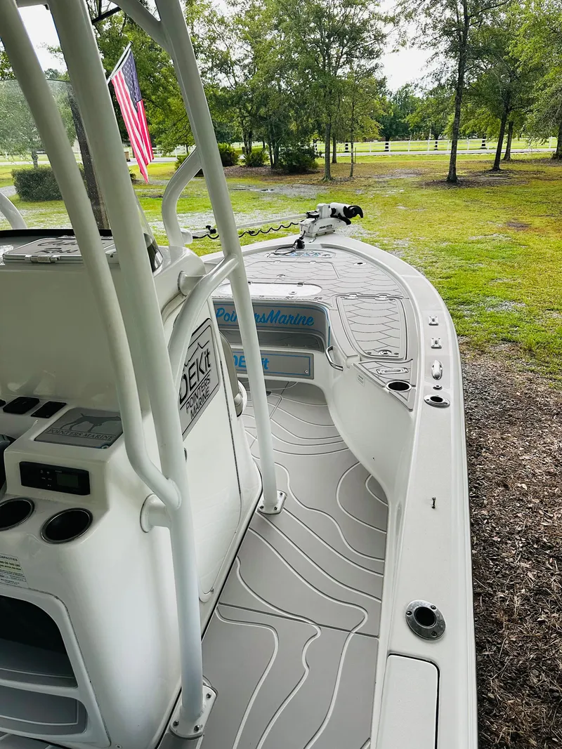 Slide: The Image of 2019 Sea Pro 248 Bay boat with deck view, parked on grassy area. - 6