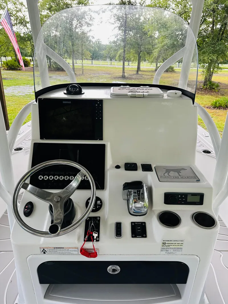 Slide: The Image of 2019 Sea Pro 248 Bay boat console with steering wheel and navigation equipment. - 7