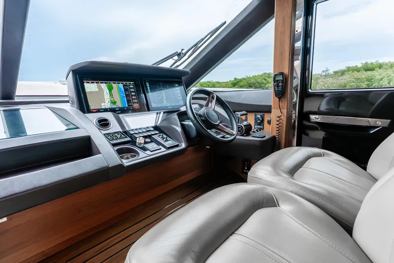 Slide: The Image of Control panel of a 2018 Princess F-68 yacht, featuring throttle and navigation controls. - 26