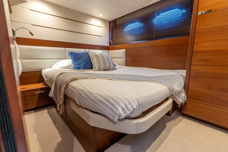 Slide: The Image of Staircase inside 2018 Princess F-68 yacht with wooden paneling and control panel. - 48