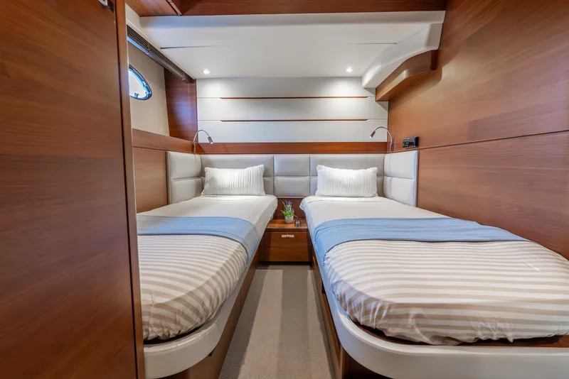 Slide: The Image of Luxurious bedroom interior of 2018 Princess F-68 yacht with modern wood paneling. - 52