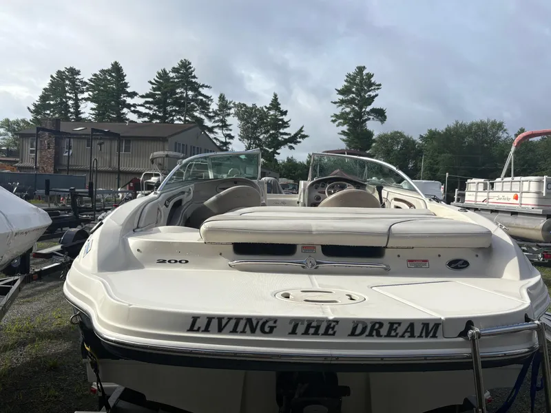 Slide: The Image of 2003 Sea Ray 200 Bow Rider boat named "Living the Dream" in a marina setting. - 3