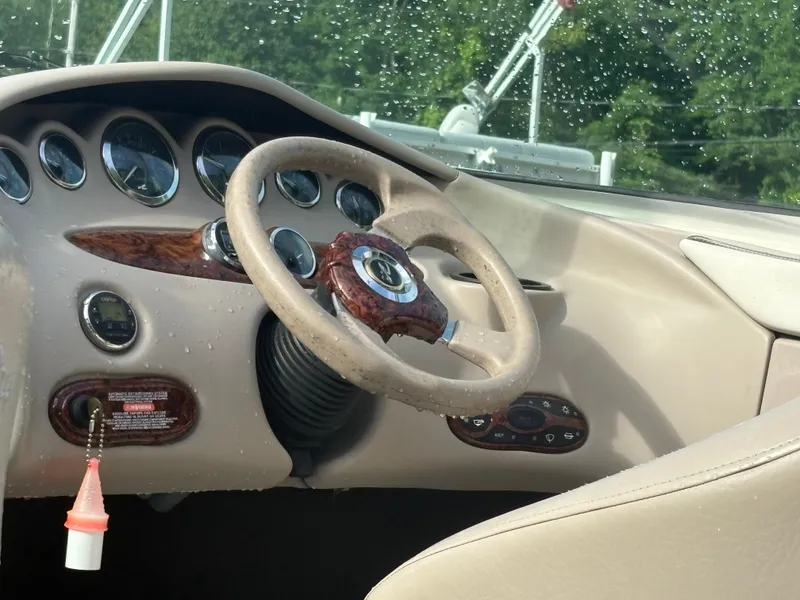 Slide: The Image of Steering wheel and dashboard of a 2003 Sea Ray 200 Bow Rider boat. - 4