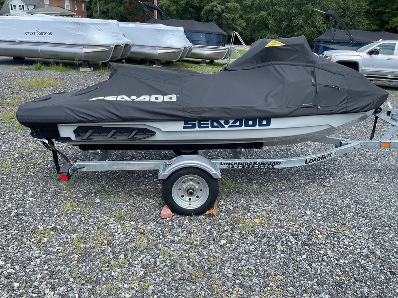 Slide: The Image of 2022 Sea-Doo Fishpro Sport 170 on trailer, covered, parked on gravel lot. - 1