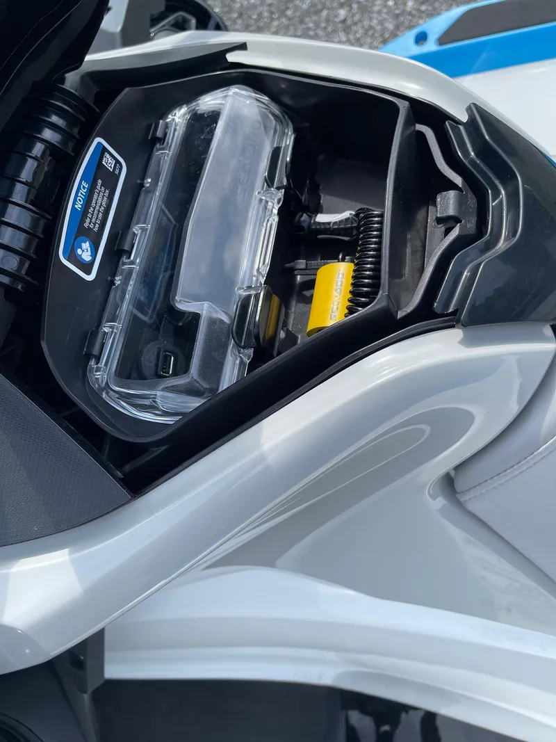 Slide: The Image of 2022 Sea-Doo Fishpro Sport 170 storage compartment with clear cover and yellow accessory. - 8