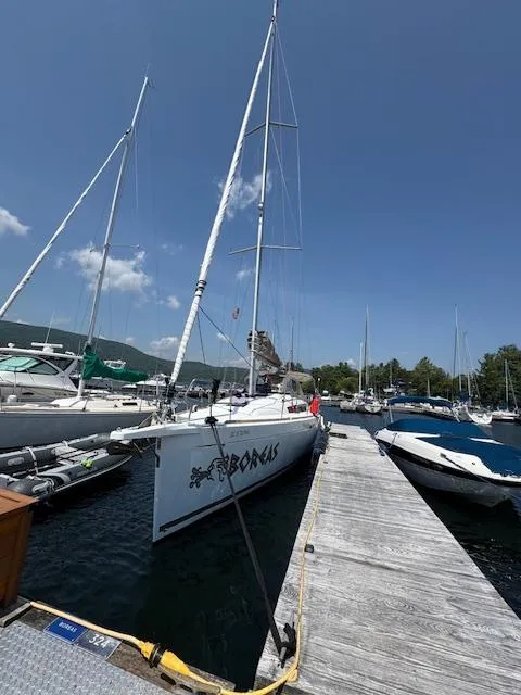 Slide: The Image of 2018 Jeanneau Sun Odyssey 389 sailboat docked at a marina under clear blue skies. - 0
