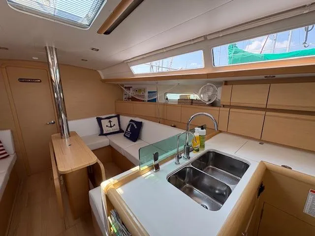 Slide: The Image of Interior of 2018 Jeanneau Sun Odyssey 389 yacht with modern kitchen and seating area. - 13