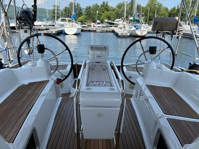 Slide: The Image of 2018 Jeanneau Sun Odyssey 389 sailboat cockpit with dual steering wheels at marina. - 2