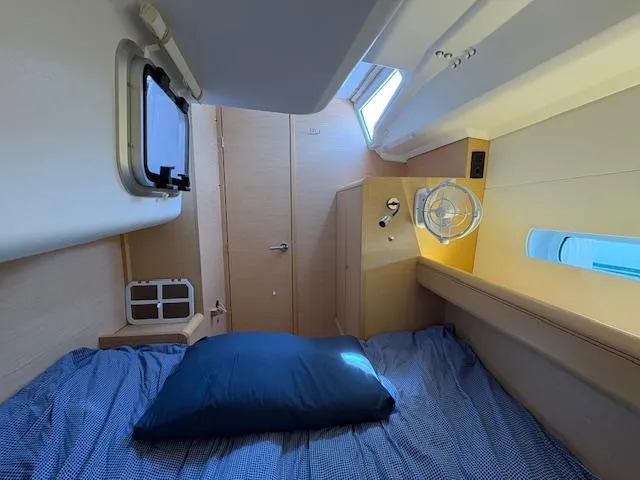 Slide: The Image of Cozy cabin interior of 2018 Jeanneau Sun Odyssey 389 sailboat with bed and porthole. - 23