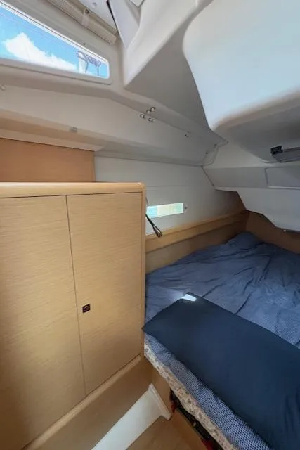 Slide: The Image of Cozy cabin interior of 2018 Jeanneau Sun Odyssey 389 sailboat with bed and storage. - 24