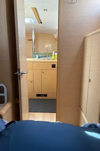 Slide: The Image of Interior view of 2018 Jeanneau Sun Odyssey 389 yacht, featuring a modern kitchen area. - 25