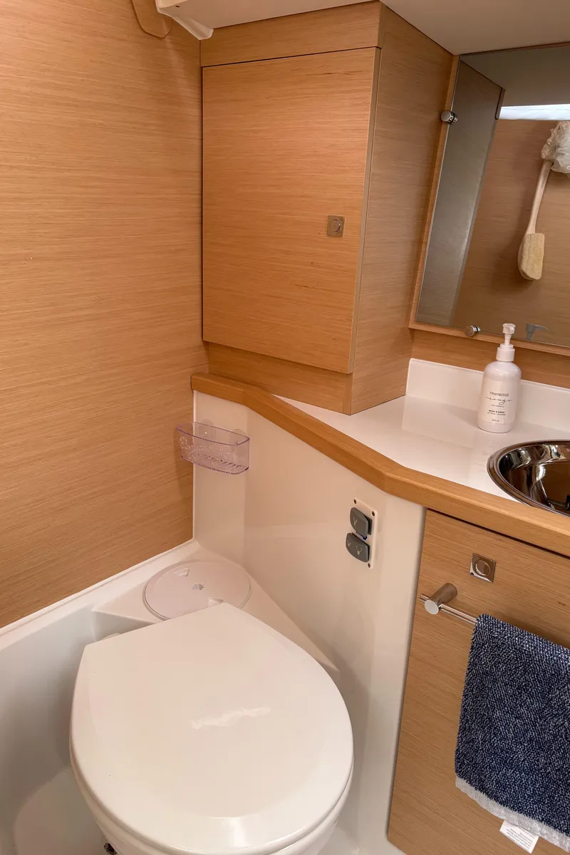 Slide: The Image of 2018 Jeanneau Sun Odyssey 389 bathroom with wooden cabinetry and modern fixtures. - 26