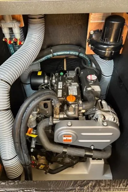 Slide: The Image of Engine compartment of a 2018 Jeanneau Sun Odyssey 389 sailboat, showcasing detailed mechanical components. - 27