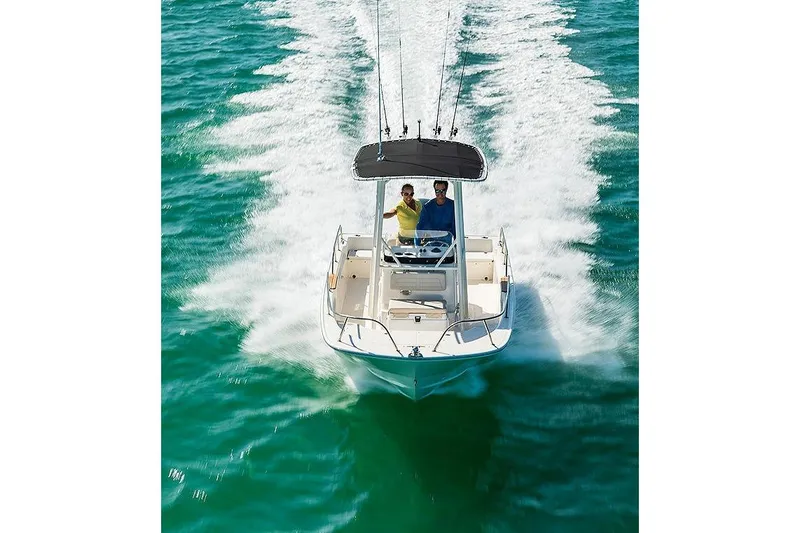 Slide: The Image of 2025 Boston Whaler 190 Montauk cruising on clear turquoise water. - 9