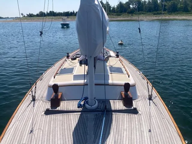 Slide: The Image of 2005 Morris M36 Daysailer on calm water, showcasing deck and mast. - 10