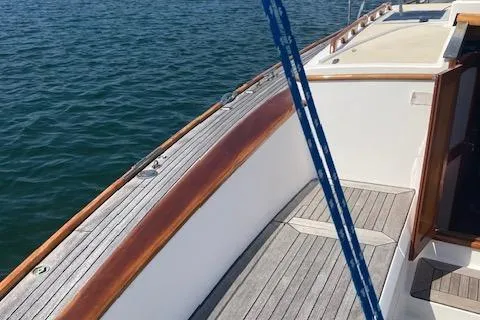 Slide: The Image of 2005 Morris M36 Daysailer deck with wooden trim on calm water. - 15