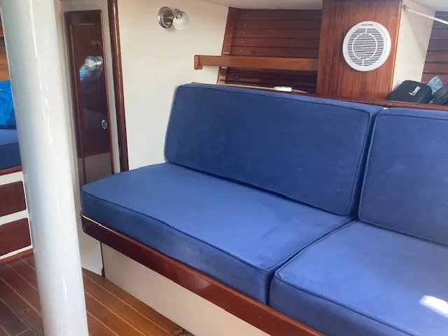 Slide: The Image of Interior of 2005 Morris M36 Daysailer with blue cushions and wooden accents. - 3