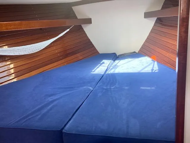 Slide: The Image of Interior cabin of 2005 Morris M36 Daysailer with blue cushions and wooden paneling. - 4