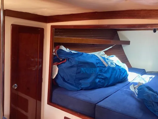 Slide: The Image of Interior cabin of 2005 Morris M36 Daysailer with blue sail bags on bed. - 5