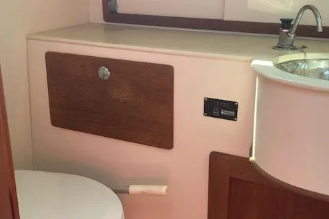 Slide: The Image of 2005 Morris M36 Daysailer interior with sink and toilet, featuring wooden accents. - 7