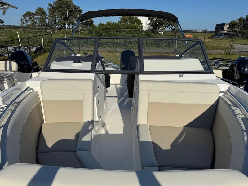 Slide: The Image of 2025 Boston Whaler 210 Vantage boat interior with beige seating and windshield. - 5