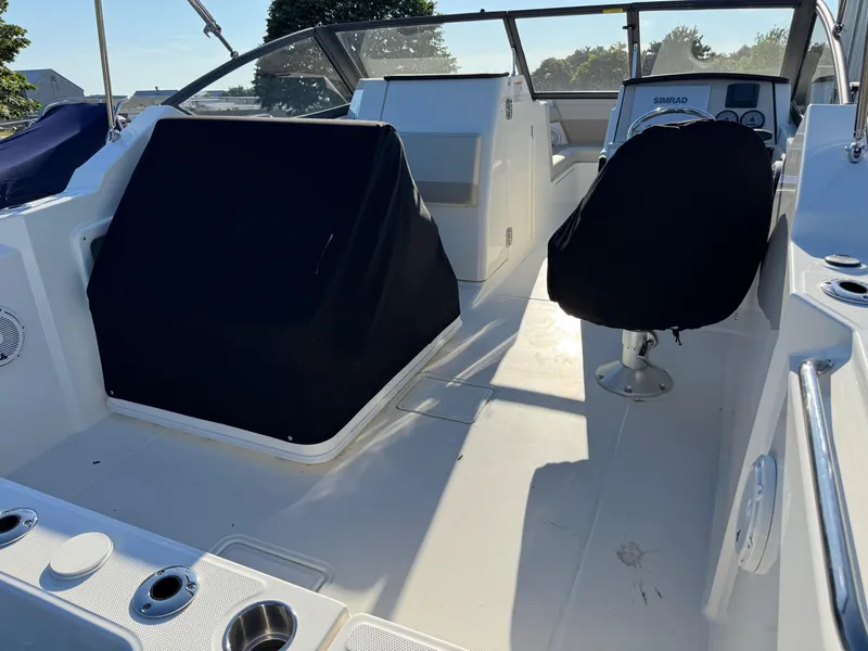 Slide: The Image of 2025 Boston Whaler 210 Vantage boat interior with covered seats and control panel. - 7