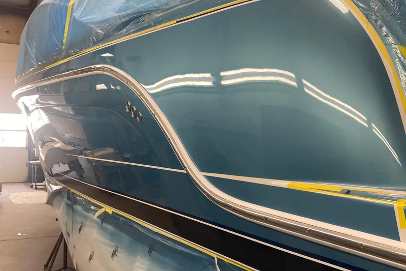 Slide: The Image of 2012 Formula 31PC boat with sleek blue hull in a workshop setting. - 10