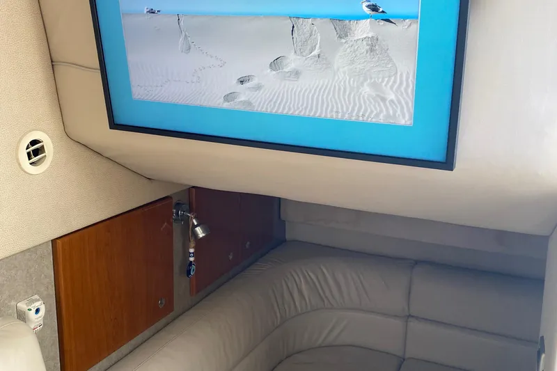 Slide: The Image of Interior of 2012 Formula 31PC boat with framed beach photo and leather seating. - 16