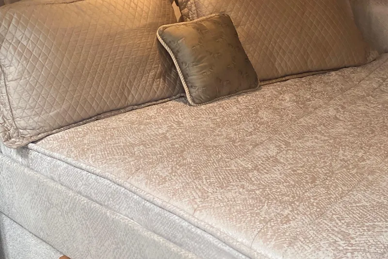 Slide: The Image of Luxurious beige bedding with quilted pillows on a Formula 31PC 2012 model. - 17