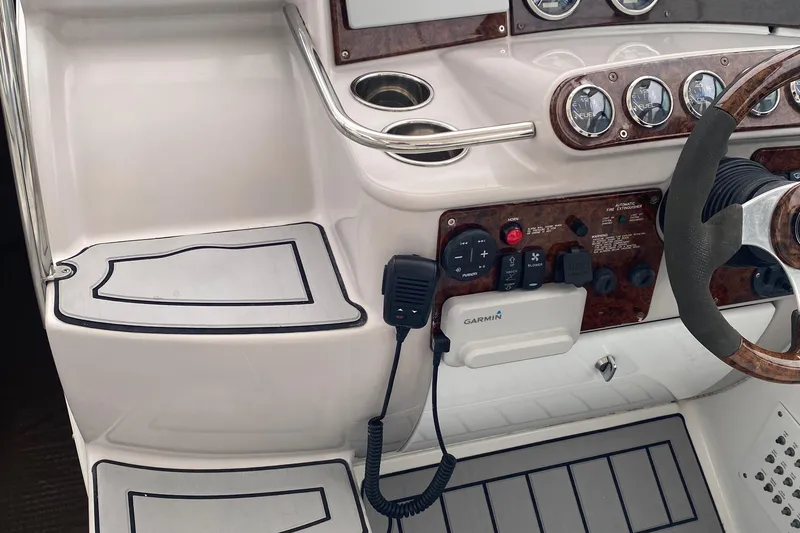 Slide: The Image of 2012 Formula 31PC boat dashboard with steering wheel, gauges, and Garmin device. - 20