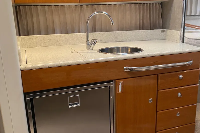 Slide: The Image of 2012 Formula 31PC yacht kitchenette with sink, countertop, and storage drawers. - 26