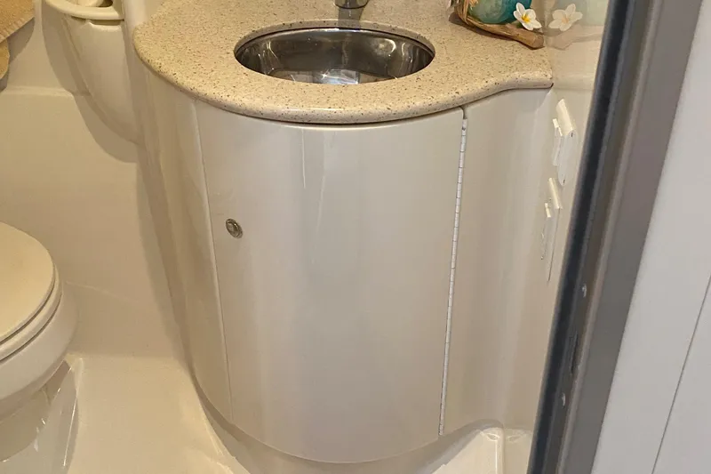 Slide: The Image of Compact bathroom sink in a 2012 Formula 31PC boat, featuring a sleek countertop design. - 27