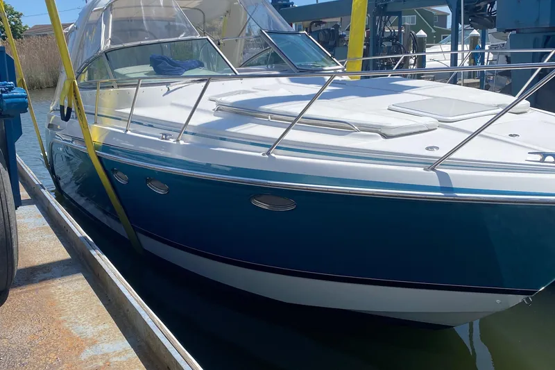 Slide: The Image of 2012 Formula 31PC boat docked, featuring sleek design and blue hull. - 6