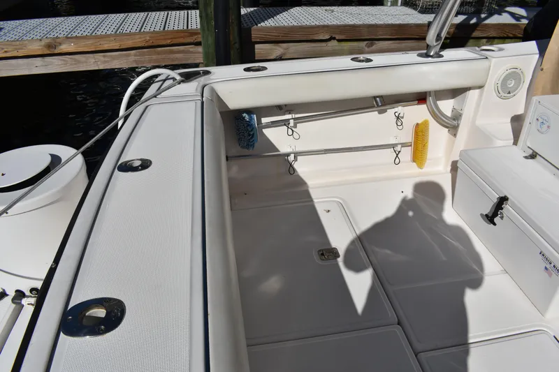 Slide: The Image of 2008 Tiara Sport Fish boat deck with storage compartments and fishing rod holders. - 11