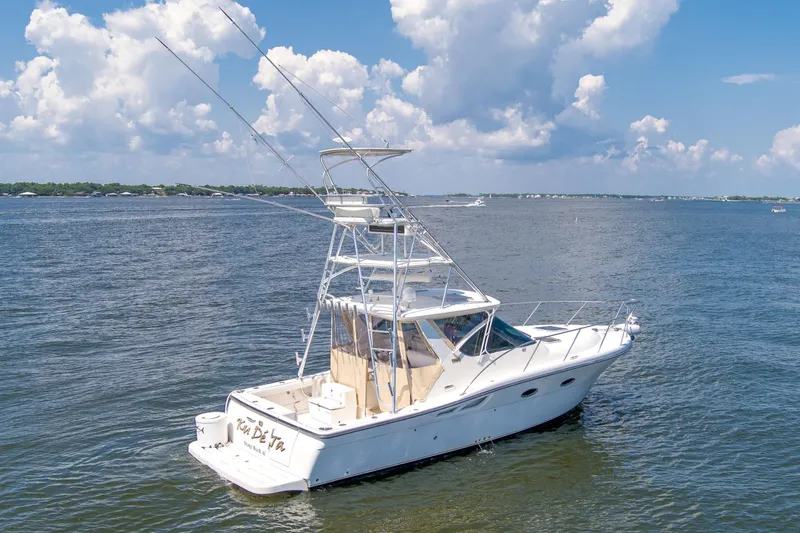 Slide: The Image of 2008 Tiara Sport Fish boat on open water under a cloudy sky. - 3