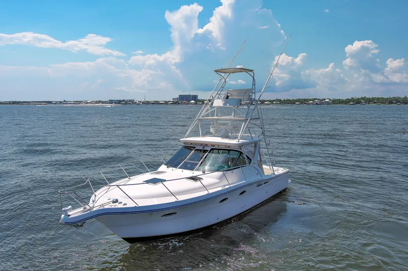 Slide: The Image of 2008 Tiara Sport Fish boat on open water under a clear blue sky. - 5